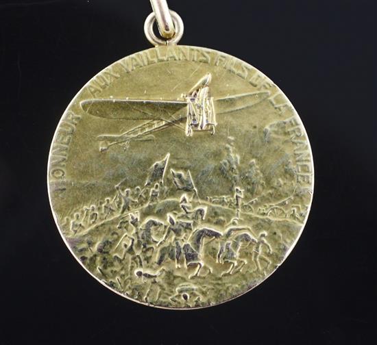 A 14k gold aviation medal inscribed Honneur Aux Vaillants Fils De La France.